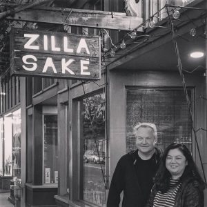 Marcus Pakiser & Midori Nakazawa standing in front of Zilla Sake in Portland Oregon